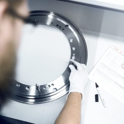 Employees of GTR Procurement specialist for cast components checks quality of ring and screws